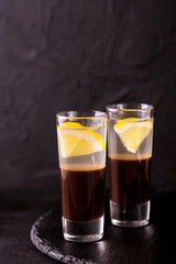 Alcoholic cocktail silver bullet with gin, coffee liqueur and lemon.