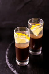 Alcoholic cocktail silver bullet with gin, coffee liqueur and lemon.