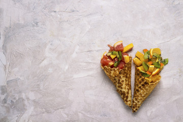 Ice cream cone waffle hand made with fruit cut on a light background with copy space. Flat lay and top view