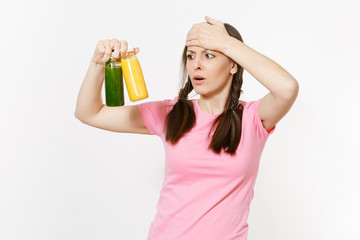 Obraz premium Fun young woman holding green, yellow detox smoothies in bottles isolated on white background. Proper nutrition, vegetarian drink, healthy lifestyle, dieting concept. Copy space for advertisement.