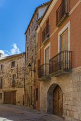 Fototapeta na wymiar Beautiful old stone houses in Spanish ancient village Sant Feliu de Pallerols in Catalonia