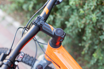 New modern road bicycle on a street background. Element of a bicycle steering wheel and helm