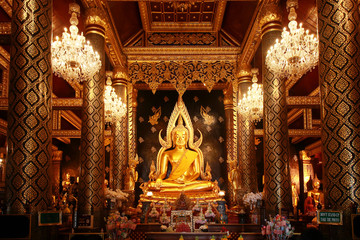 beautiful big golden buddha statue name Phra Phuttha Chinnarat at Wat Phra Si Rattana Mahathat temple. calm and peaceful face of worship buddha statue illuminated. Buddhism religion concept