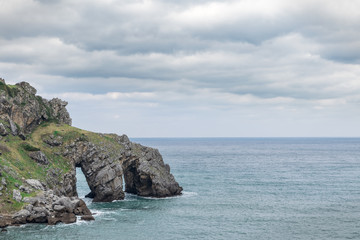 awesome cliffs with holes and caves on the rocks of the atlantic coastline.