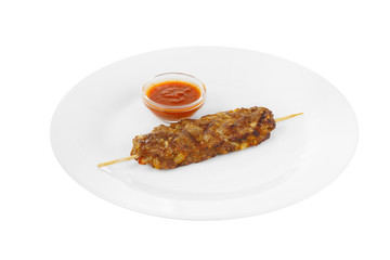 Kebab, beef, lamb, pork grilled meat, barbecue, without side dish on a plate, isolated on white background. Ketchup, tomato red sauce. Side view For the menu