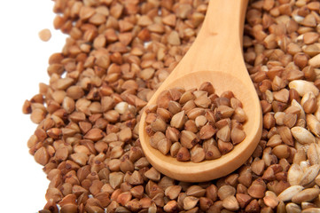 Wooden spoon with grain on the white