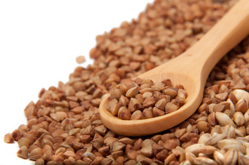 Wooden spoon with grain on the white