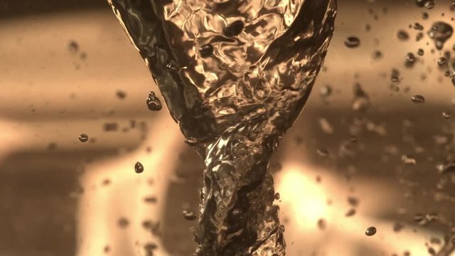 A slow motion swirling clip of water with bubbles eventually fading.
