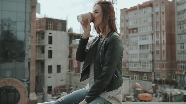 Urban style, woman drink coffee in city