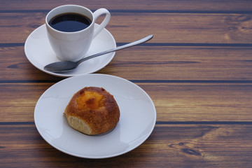 fresh homemade  scone with orange jam and coffee Cup on wooden table