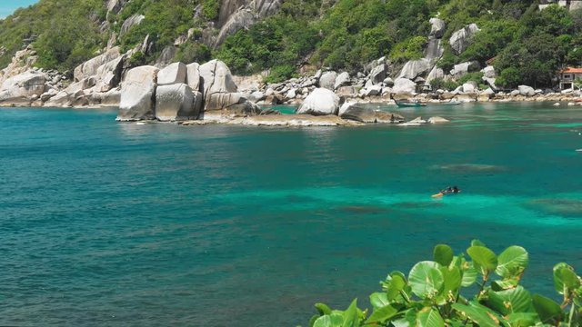 Tanote Bay on sunny day. Rippled ocean water over beautiffull Coral Reef. Divers practice in the blue bay. Koh Tao, Thailand