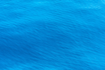 Obraz na płótnie Canvas Blue water background with regular wave structure, Albania