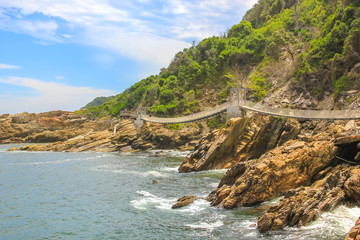 Suspended Bridges during trekking route over Storms River Mouth in Tsitsikamma National Park, Eastern Cape, near Plettenberg Bay in South Africa. Famous tourist destination along Garden Route.