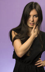 Portrait of a Charming Brunette girl on a Purple Background