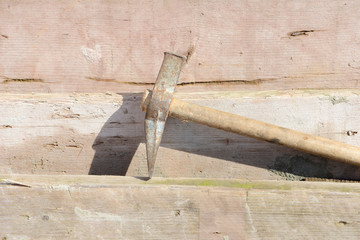 hammer at scaffolding plate on construction site