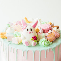 Pink cake with bunny for children's birthday. Copy space