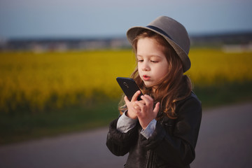 little funny girl with smartphone