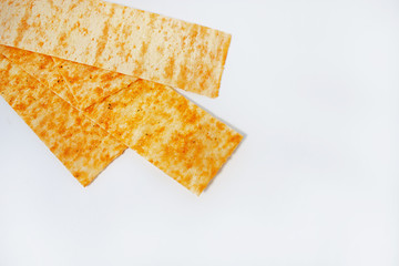 golden potato chips on a white background