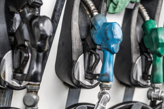 Gasoline and diesel pump nozzles in a gas station closeup. Filling gun, gas refueling nozzle, gasoline pump