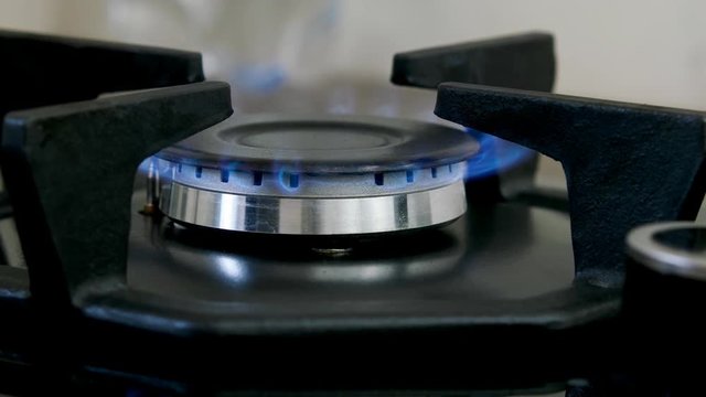 Close up natural gas inflammation in stove burner.