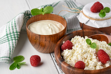 Dairy products milk cottage cheese, sour cream and fresh raspberry