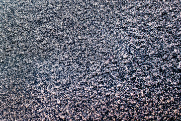 white snowflakes on the dark glass. background, texture