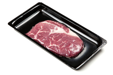 Raw steak in an airtight packaging