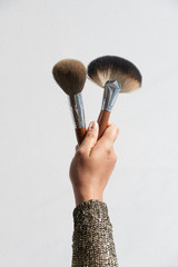 Hand Holding Makeup Brushes