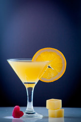 Isolated drink. Glass of orange juice and slices of orange fruit isolated on dark background