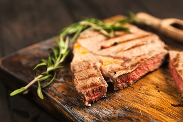 Grilled steak on wooden cutting board
