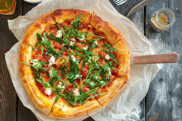 delicious italian pizza served on wooden table top view