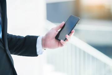 Businessman holding mobile smartphone