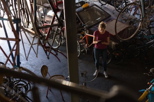 Female mechanic using digital tablet