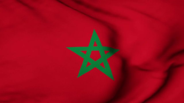 The Morocco flag waving in the wind. The Moroccan flag flaps in the breeze, filling the whole frame. See portfolio for similar and much more!