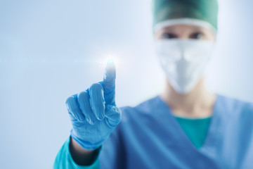 Female surgeon using a touch screen interface