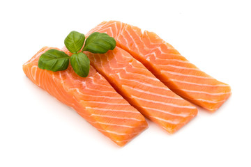 Fresh salmon fillet with basil on the white background.