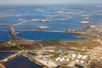 Oil field on the lake lake, aerial view