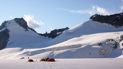base camp with many tents on a high alpine glacier in the Alps near Chamonix