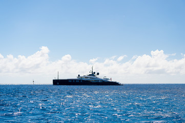 Ship or yacht in sea on blue sky in gustavia, st.barts. Luxury travel on boat and adventure. Vessel and water transport. Summer vacation and holiday destination