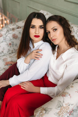 The beautiful girls sitting on the sofa