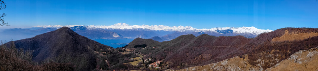 Fototapeta premium panorama on the Alps and Lake Maggiore from the Lombard pre-Alps, valley of woods and small villages