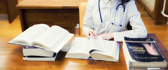 classical training. background a medical student for textbooks. The study of surgery by a beautiful girl in the library