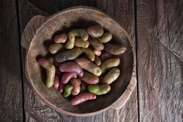 rustic wooden bowl filled with melloco tuber  closeup in Ecuador