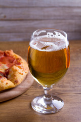 Beer and pizza. Glass of beer. Ale and appetizer snack.