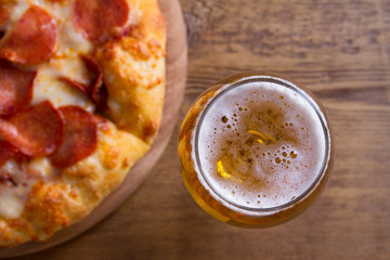 Beer and pizza. Glass of beer. Ale and appetizer snack. View from above, top