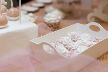 cakes in a vase on the buffet.