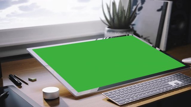 Green Screen Computer.  Computer and keyboard in the office. Green screen footage for image replacement