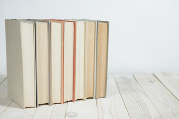 Pile of old pastel colors books stacked. Selective focus with copy space