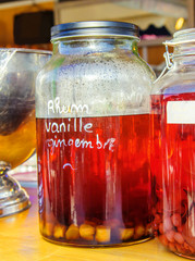 Bottle of rum with ginger drink in background