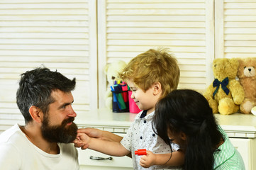 Young family spends time in playroom. Mom, dad and boy